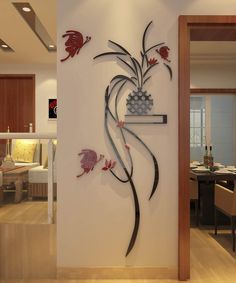 the wall is decorated with metal flowers and leaves, along with an open dining room door