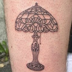 a tattoo on the leg of a person with a lamp