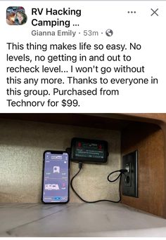 an iphone is plugged in to a wall charger on the shelf next to a phone