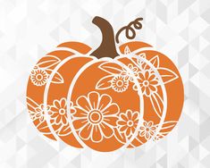 an orange and white pumpkin with flowers on it's side, against a geometric background