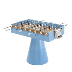 a blue foosball table sitting on top of a white surface