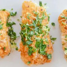 three pieces of food on a plate with parsley sprinkled on top and another piece of bread in the middle