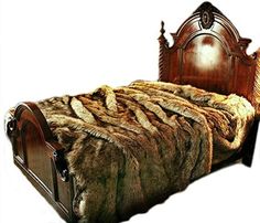 the bed is made with fur and wooden headboard