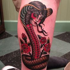 a woman with a snake tattoo on her leg