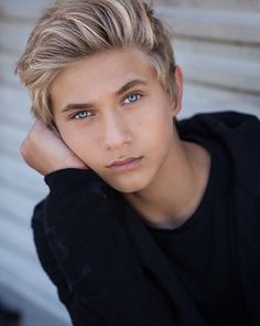 a young man with blonde hair and blue eyes