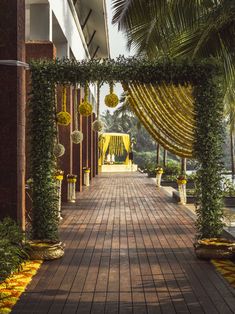 the walkway is lined with yellow flowers and greenery