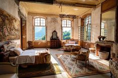 an old bedroom with antique furniture and large windows