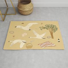 a beige rug with white birds and trees on it next to a potted plant