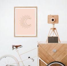 a white bicycle parked in front of a wooden frame with an om shan symbol on it