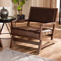 a brown chair sitting on top of a hard wood floor next to a wooden table