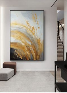 an abstract painting hangs on the wall next to a couch and ottoman in a modern living room