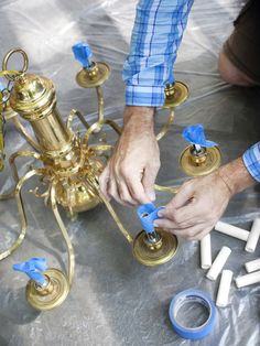 a man is working on something that looks like a chandelier