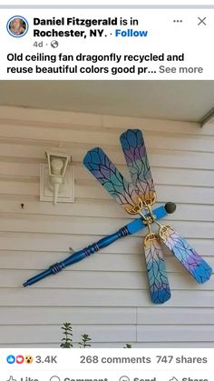 a blue dragonfly on the side of a house