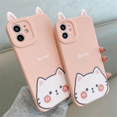 two pink cases with cats on them, one is holding the other case in her hand