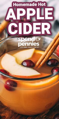 homemade hot apple cider recipe with cinnamon sticks and apples in the bowl, on a wooden table