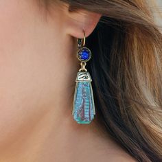 "Fascination with ancient Egyptian artifacts profoundly influenced archaeology and popular culture. The undisturbed intact articles found in Tut's tomb became icons of romance and mystery. Bohemian glass factories produced decorated elements to be used in the creation of \"artifact\" jewelry. I designed these Earrings using decorated sculptured blue glass pendants depicting an ancient goddess. They are genuine vintage elements from the 1930s. Size: 2.75\" long by 0.75\" wide Made in our Los Ange Blue Goddess, Egypt Hieroglyphics, Egyptian Earrings, Horus Eye, Eye Of Horus Necklace, Ancient Egyptian Artifacts, Jewelry Wishlist, Eye Of Ra, Egyptian Artifacts