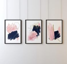 three framed art pieces hang on the wall