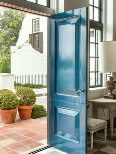 an open blue door leading to a patio