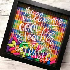 a black frame with colorful crayons and the words, the influence of a good teacher can never be passed