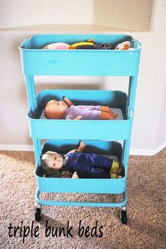 two children's toys are sitting in plastic bins on the carpeted floor