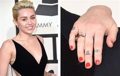 the woman is wearing a black dress and has two different rings on her fingers, one with