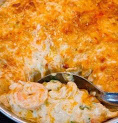 a close up of a casserole dish with shrimp and cheese