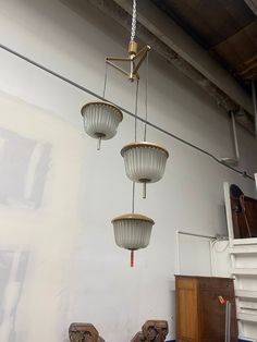 three light fixtures hanging from the ceiling in a room