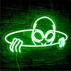 a green neon sign with a cartoon character on it's face and headphones