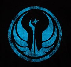 a man wearing a star wars t - shirt with a blue circle on the front