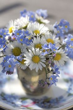 a vase filled with blue and white flowers