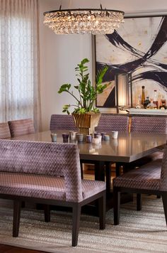 a dining room table with chairs and a chandelier