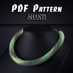 a green and gold necklace on a black background with the words, pattern shanti