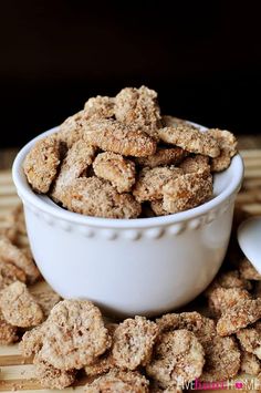 a white bowl filled with cookies on top of a wooden table