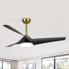 a black ceiling fan in a white room