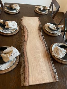 a wooden table with plates and napkins on it that has been cut into pieces