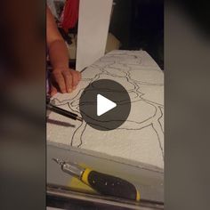 someone is drawing on a piece of paper