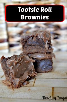 two chocolate brownies cut in half on top of a cutting board with the words tootsie roll brownies