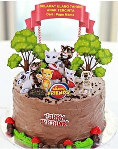 there is a birthday cake with many animals on it