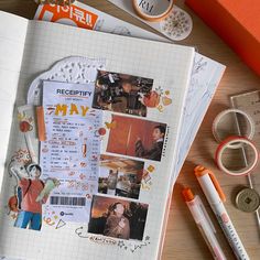 an open notebook with pictures and other items on it next to scissors, tape, markers, and paper clips