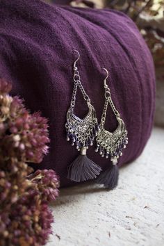 Inspired by traditional Indian jewellery, these Jaipur earrings are designed to wow. Delicate silver-tone metal with coloured glass beads and a single cotton tassle.  Matching necklace available.  Handcrafted by The Daughters of the Ganges, a fair trade organisation who partner with artisan communities in India.  #ethical #ethicaljewellery #boho #bohoearrings #sustainable Purple Earrings, Coloured Glass, Ethical Jewelry, Matching Necklaces