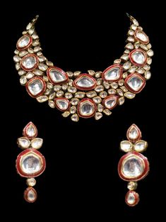 "Rehana Kundan Choker Ruby Set Setting the tone for this season's wedding celebrations! A traditional piece crafted with centuries old form of handwork, this set exhibits beautiful kundan and lab-created emerald and ruby stone accents,. The set includes a pair of matching earrings. Approximate earrings length is 2.75\". SET INCLUDES : Necklace & Earrings * Tikka can be added Details: Handcrafted Metal: Gold Plated, Metal Alloy Stone: Kundan & Ruby Stones Closure: Post for Pierced Ears DE Kundan Bridal Necklace With 17 Jewels For Festivals, Kundan Necklace With 17 Jewels, Hand Set Kundan Necklace For Reception And Festivals, Festive Hand-set Kundan Necklace For Reception, Coral Jewelry Set, Kundan Choker Set, Gemstone Choker Necklace, Indian Choker Necklace, Ruby Set