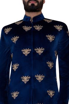 Navy blue achkan-style sherwani with all over hand embroidered motifs.
Components:1
Hand embroidered
Neckline:Mandarin collar
Sleeve Length:Full
Fabric:Velvet
Color:Blue
Single button on sleeve hem
Closure: Concealed front placket
Note: Safa and pants worn by the model is not for sale - Aza Fashions Designer Sherwani With Gold Embroidery, Royal Sherwani With Zari Work For Festive Occasions, Royal Sherwani With Zari Work For Formal Occasions, Royal Style Formal Sherwani With Zari Work, Royal Festive Sherwani With Zari Work, Royal Fitted Kurta For Festive Occasions, Blue Embroidered Sherwani For Festivals, Royal Festive Kurta For Eid, Royal Bandhgala For Eid