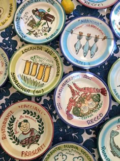 many plates with different designs on them