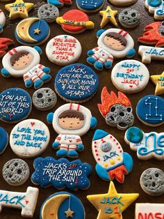 decorated cookies with stars, moon and astronaut's names are on a table top