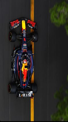 a red bull racing car driving down the road