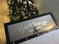 a christmas tree is in the background behind a sign that reads burkhard est 2009