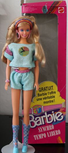 a barbie doll is standing in front of a box