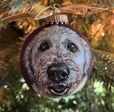 a dog ornament hanging from a christmas tree