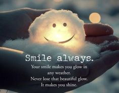 a person holding a small light in their hand with the caption smile always your smile makes you glow in any weather