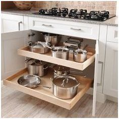 an open cabinet with pots and pans on it